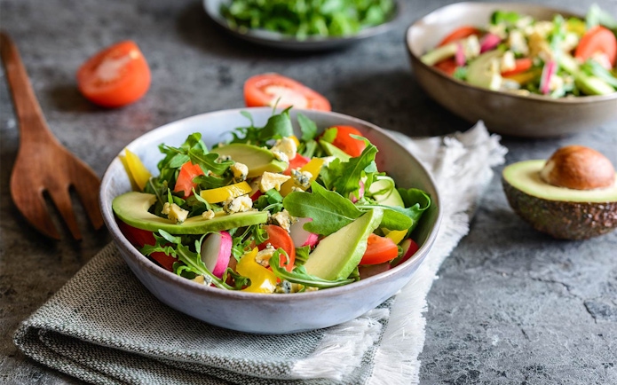 Salad with avocado, arugula, and tomatoes at International buffet, Good Old Days.