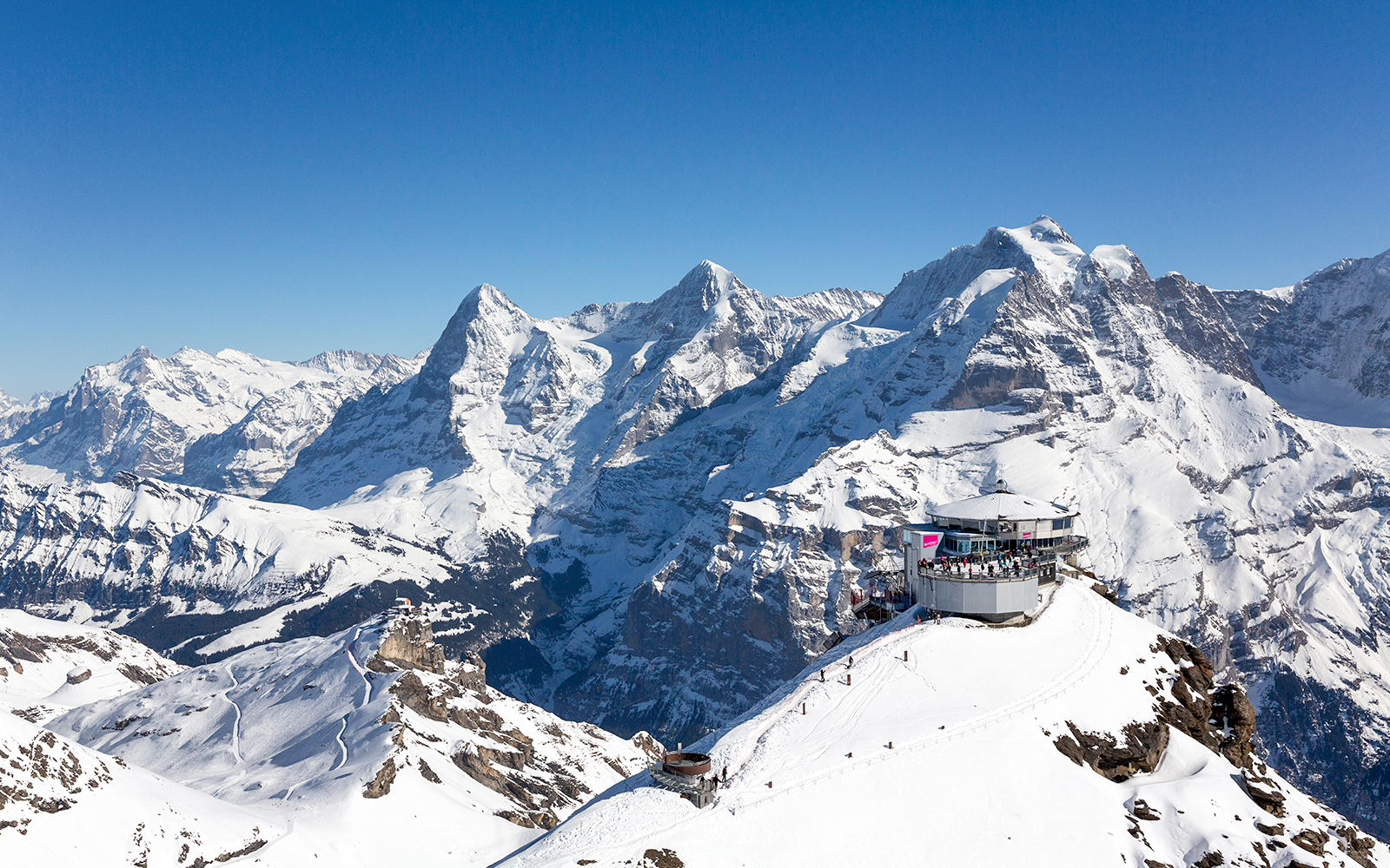 Schilthorn Piz Gloria with snowy Alps backdrop, view from Stechelberg.