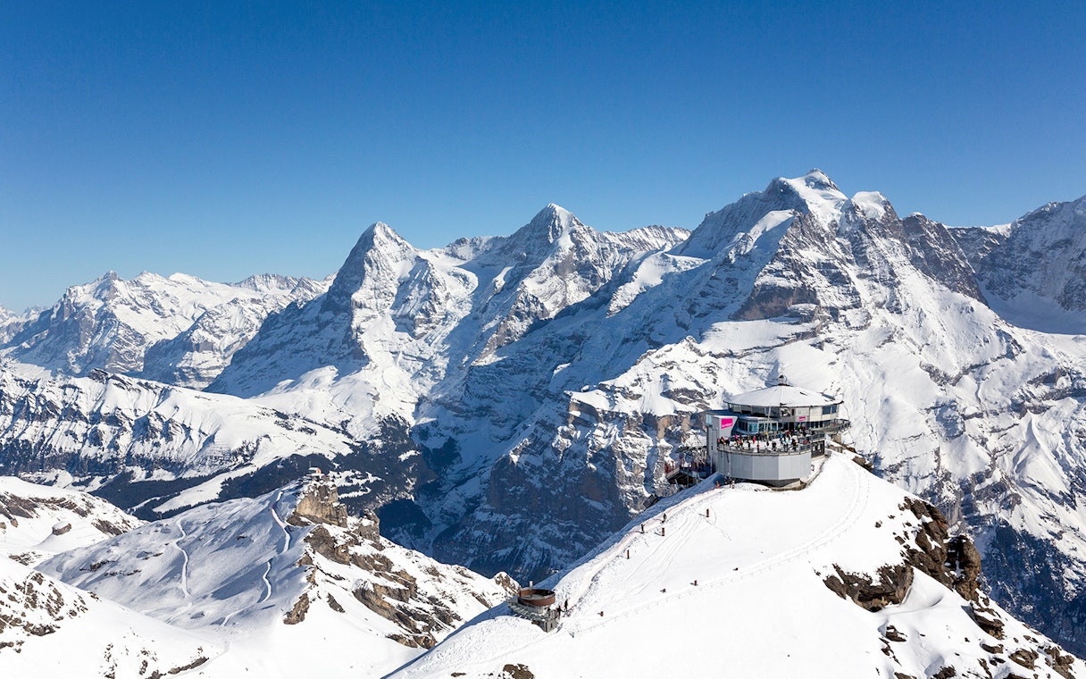 Schilthorn Piz Gloria with snowy Alps backdrop, view from Stechelberg.