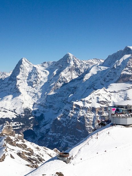 Schilthorn Piz Gloria with snowy Alps backdrop, view from Stechelberg.
