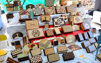 Wooden crafts displayed at Ipanema Street Market, Rio de Janeiro, featuring geometric patterns and local motifs.