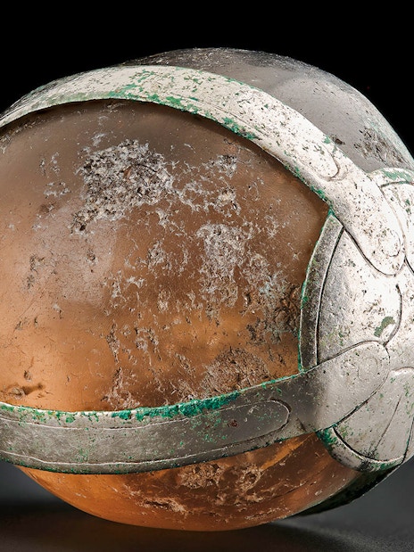 Viking Age rock crystal pendant with intricate metalwork.