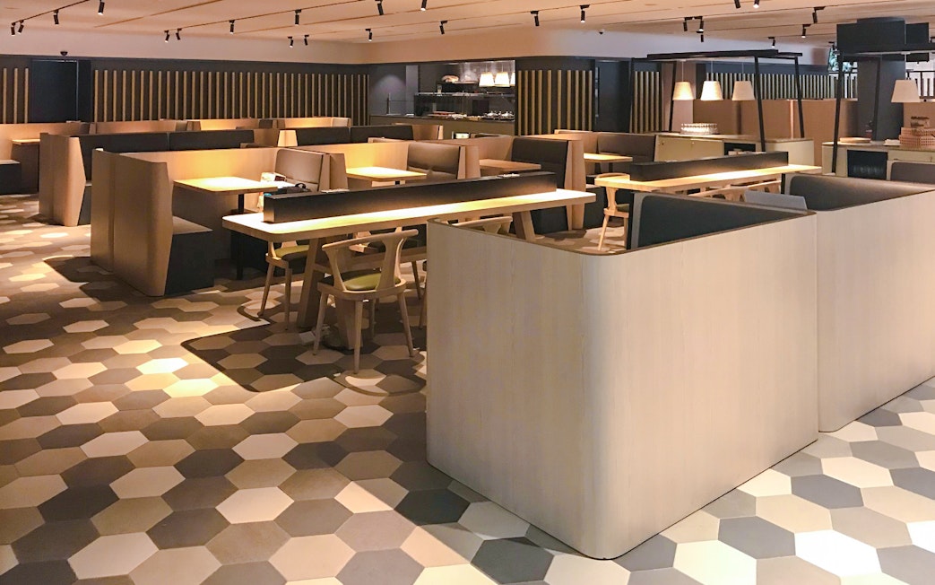 Dining area at BLOSSOM by SATS, Plaza Premium Lounge, Singapore with modern seating.