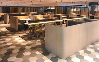 Dining area at BLOSSOM by SATS, Plaza Premium Lounge, Singapore with modern seating.