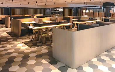 Dining area at BLOSSOM by SATS, Plaza Premium Lounge, Singapore with modern seating.