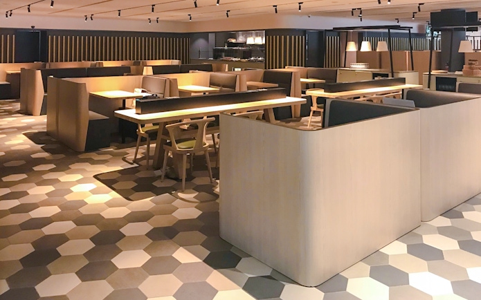 Dining area at BLOSSOM by SATS, Plaza Premium Lounge, Singapore with modern seating.