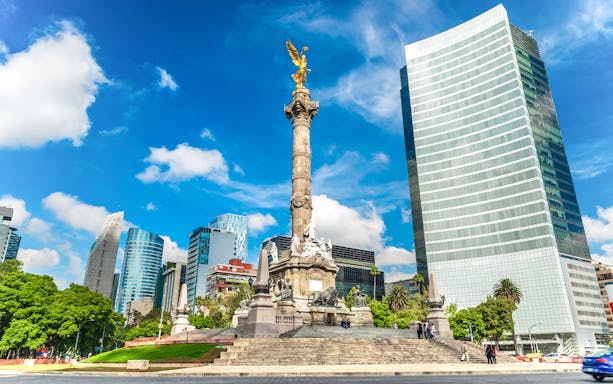 Angel of Independence monument in Mexico City with surrounding skyscrapers.