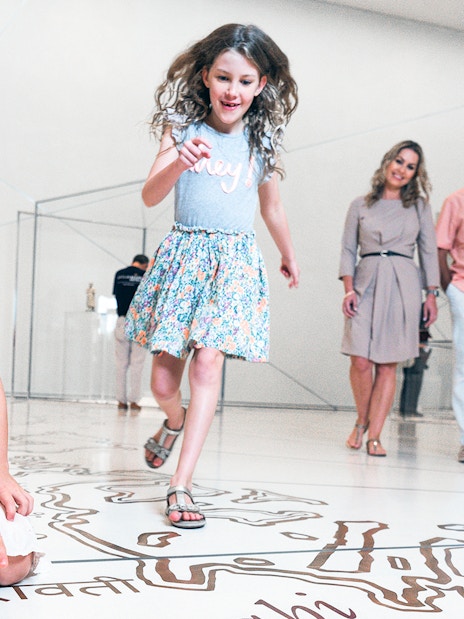 Visitors enjoying interactive exhibits at the Louvre Museum Abu Dhabi.