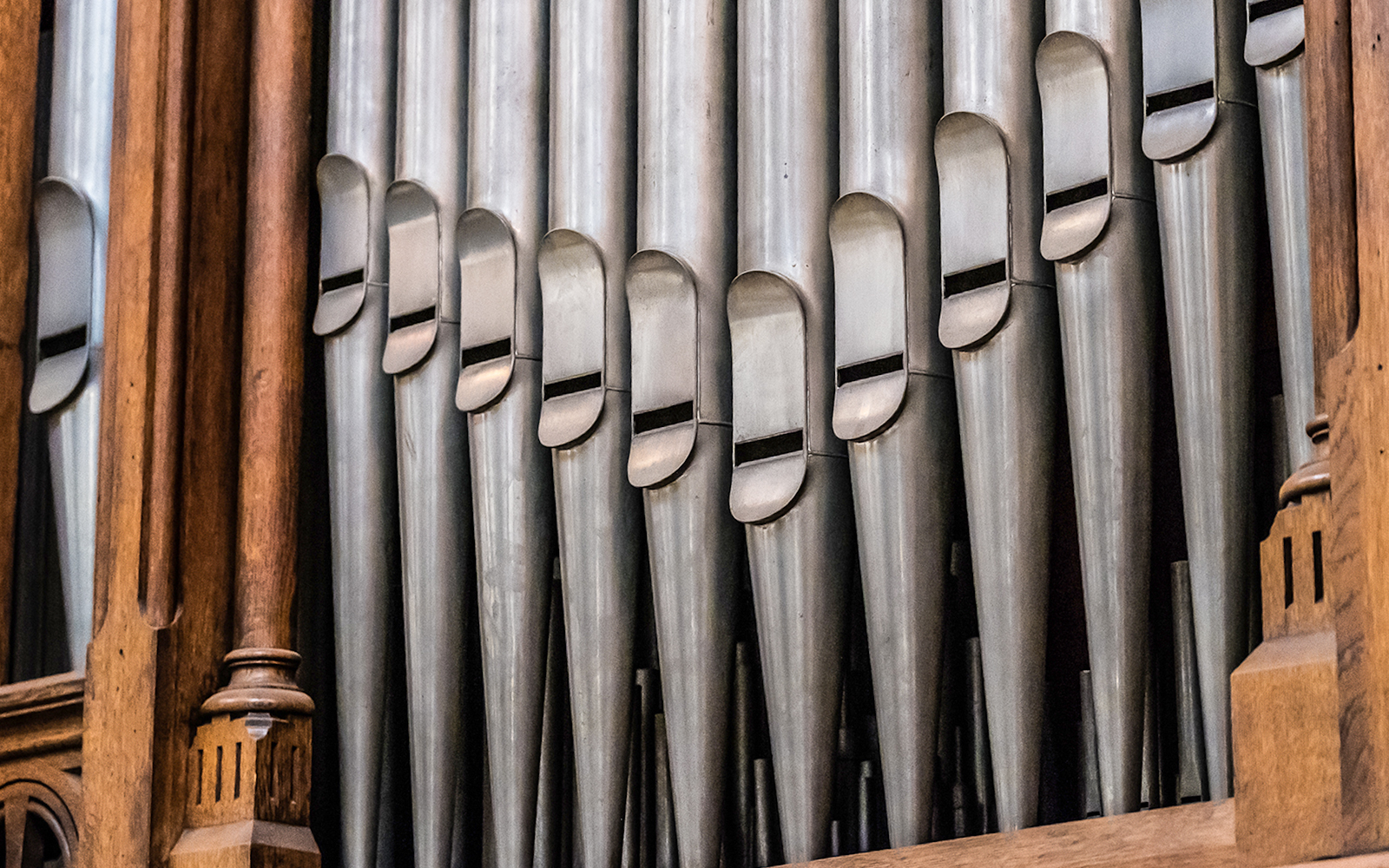 Church pipe organ pipes with wooden casing.