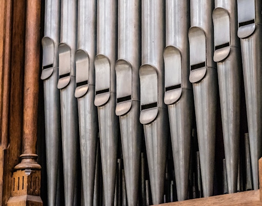 Church pipe organ pipes with wooden casing.