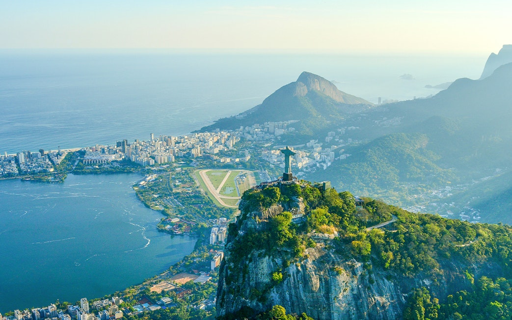 Aerial view of Rio de Janeiro with Christ the Redeemer, Corcovado Mountain, Sugarloaf Mountain, and Guanabara Bay.