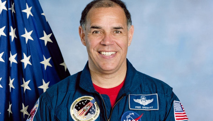 Rocket display at Kennedy Space Center with visitors exploring exhibits.