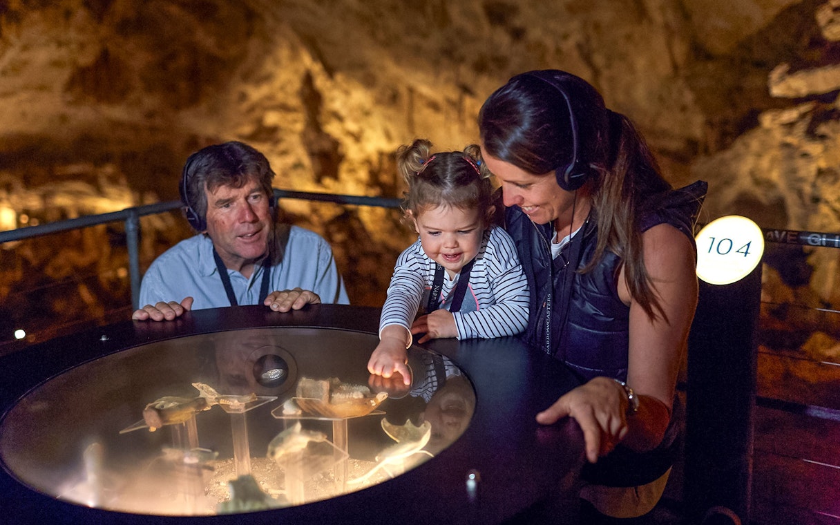 Family exploring Mammoth Cave exhibit on self-guided audio tour, Margaret River.