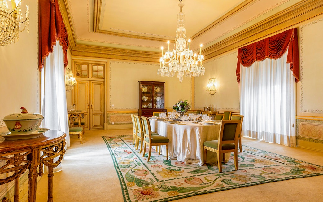 Dining room in D Maria Pavilion, National Palace of Queluz, featuring a chandelier and set table.