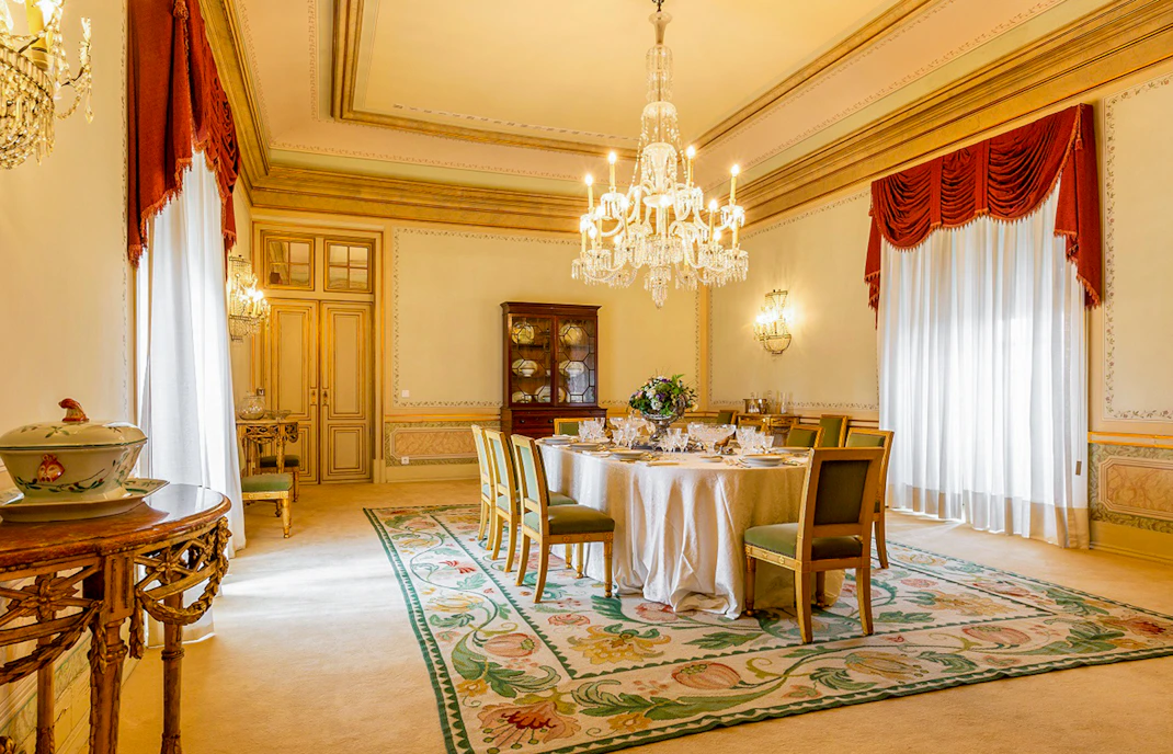 Dining room in D Maria Pavilion, National Palace of Queluz, featuring a chandelier and set table.