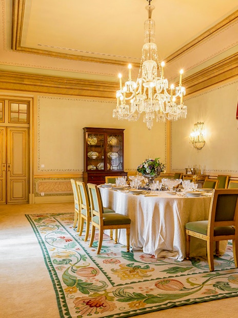 Dining room in D Maria Pavilion, National Palace of Queluz, featuring a chandelier and set table.