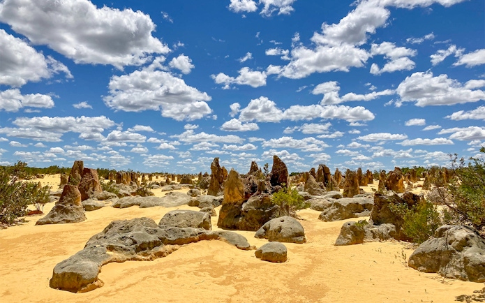 Pinnacles Desert limestone formations under a blue sky, Australia.