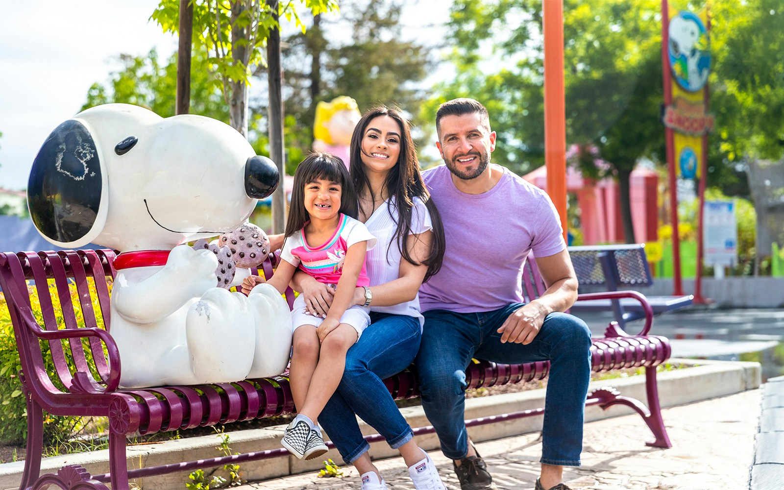 Family sitting with Snoopy statue at California's Great America, Planet Snoopy area.