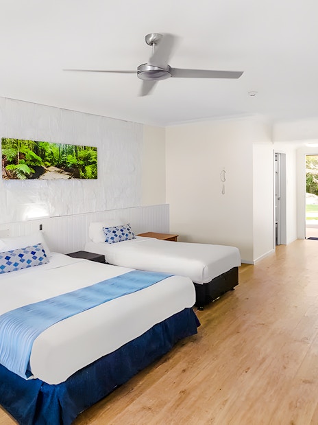 K'gari Beach Resort room with two beds, kitchenette, and garden view.