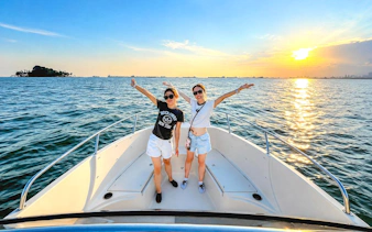Two people on a speedboat during sunset cruise, Southern Islands Tour, Sentosa, Singapore.