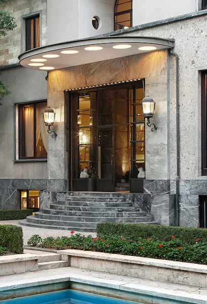 Entrance of Villa Necchi Campiglio in Milan with stone steps and garden.