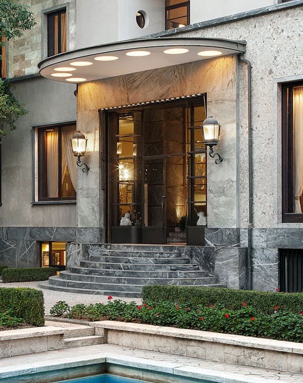 Entrance of Villa Necchi Campiglio in Milan with stone steps and garden.