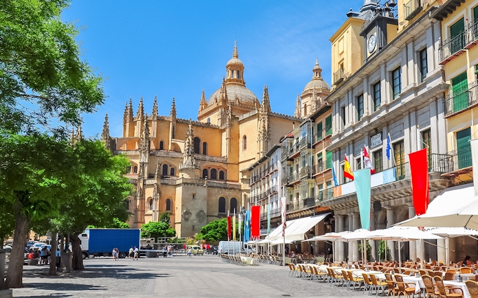 Segovia main square with cathedral and outdoor cafes.