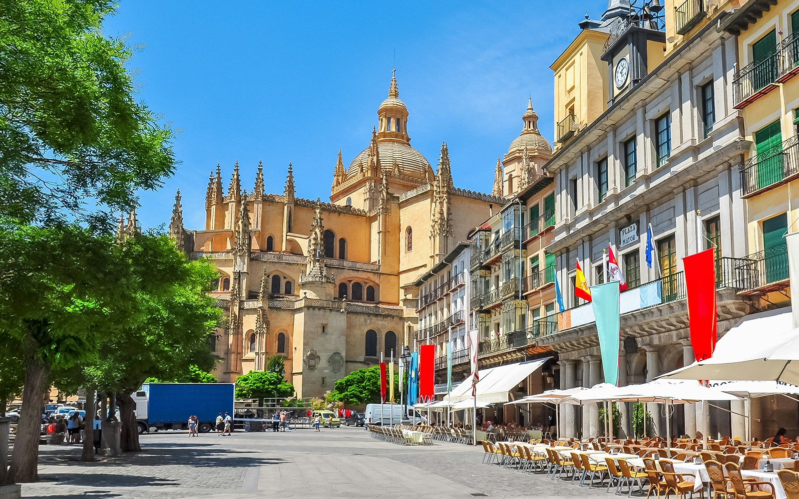 Segovia main square with cathedral and outdoor cafes.