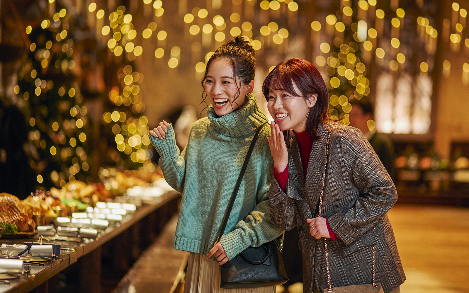 Visitors enjoying Christmas decorations in the Great Hall at Harry Potter Studio Tour Tokyo.