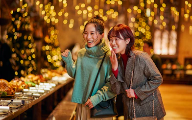 Visitors enjoying Christmas decorations in the Great Hall at Harry Potter Studio Tour Tokyo.
