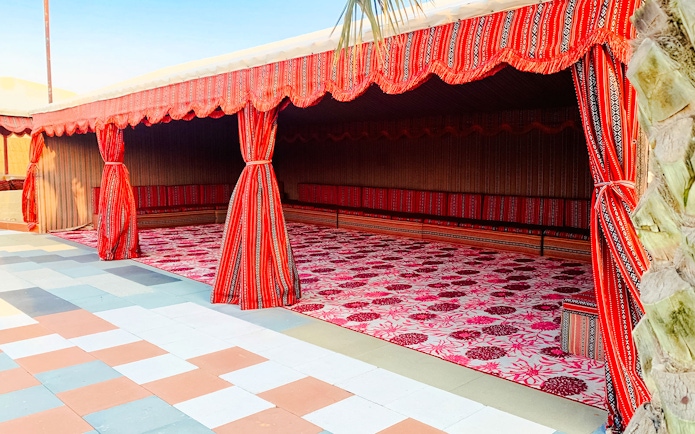 Traditional Bedouin tent setup at Abu Dhabi desert safari campsite.