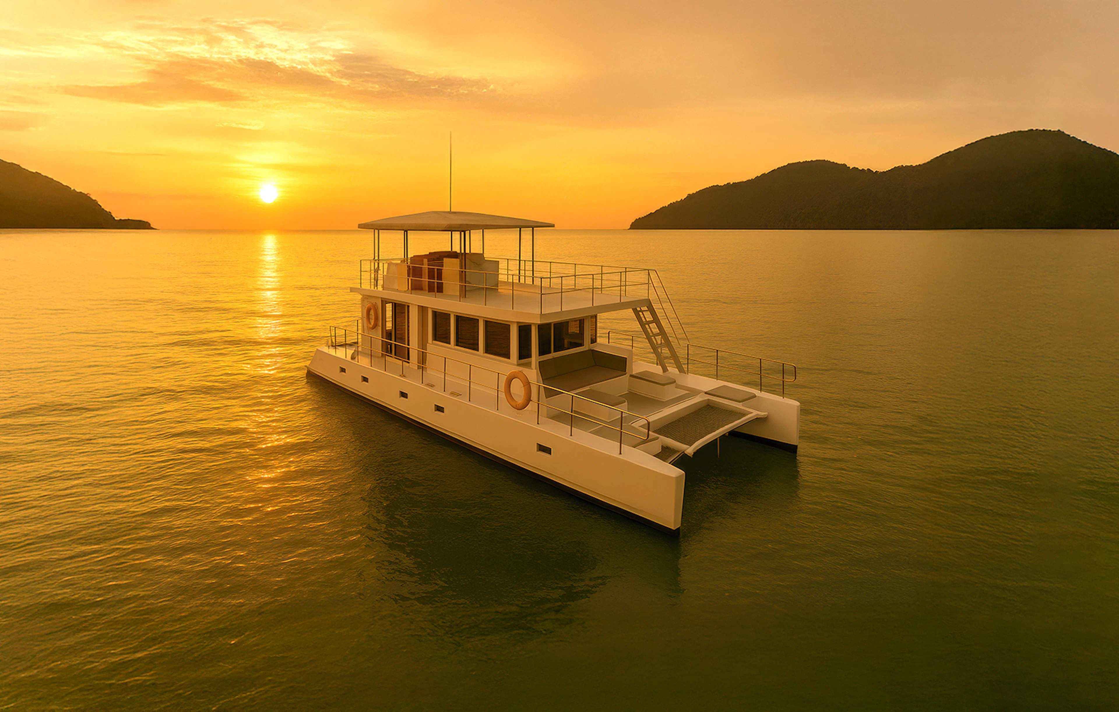 Catamaran sailing during Langkawi sunset cruise with islands in the background.