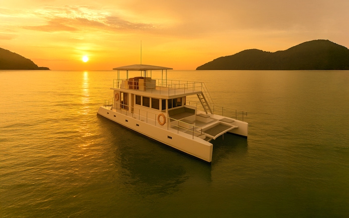 Catamaran sailing during Langkawi sunset cruise with islands in the background.