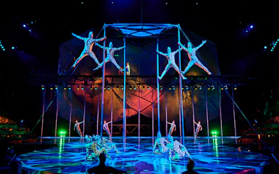 Acrobats performing on poles in Mystère show, Las Vegas.
