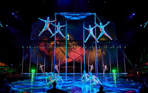 Acrobats performing on poles in Mystère show, Las Vegas.