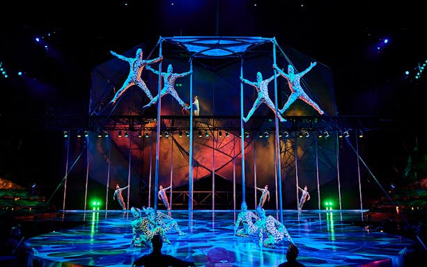 Acrobats performing on poles in Mystère show, Las Vegas.