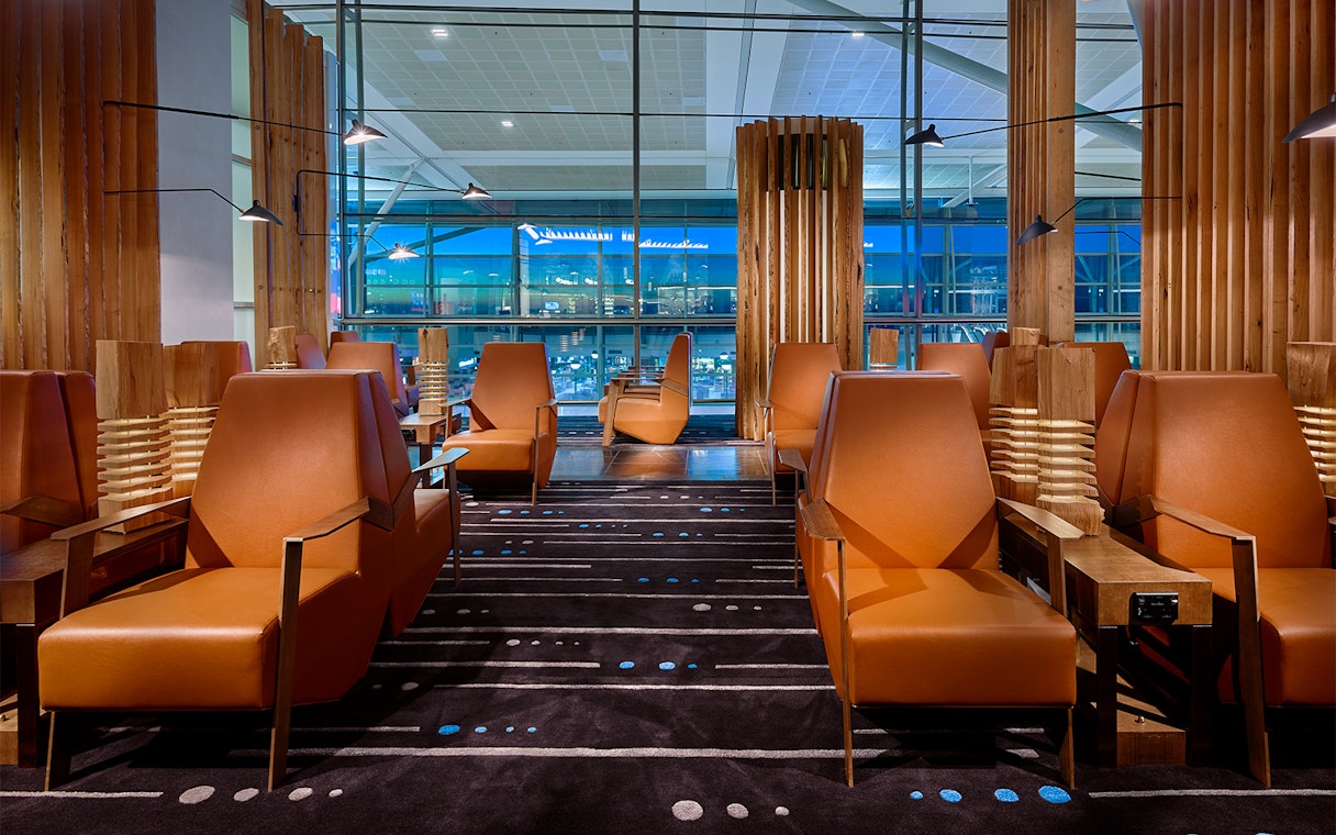 Plaza Premium Lounge seating area with leather chairs and large windows.