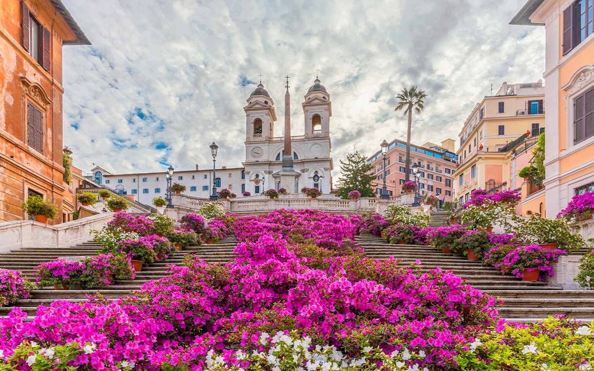 Spanish Steps in Rome adorned with vibrant pink flowers.