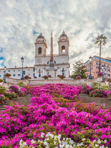 Spanish Steps in Rome adorned with vibrant pink flowers.