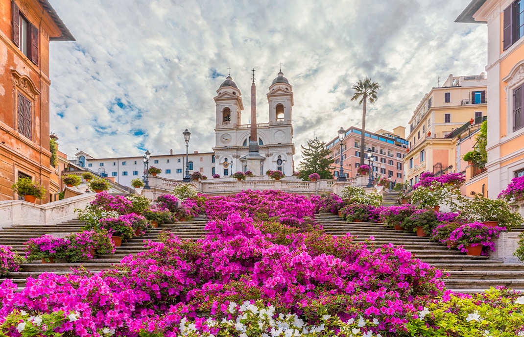 Spanish Steps adorned with vibrant flowers in Rome, Italy.