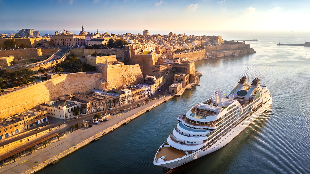 Malta harbor view with cruise ship, historic buildings, and blue sea on a one-day Malta cruise.