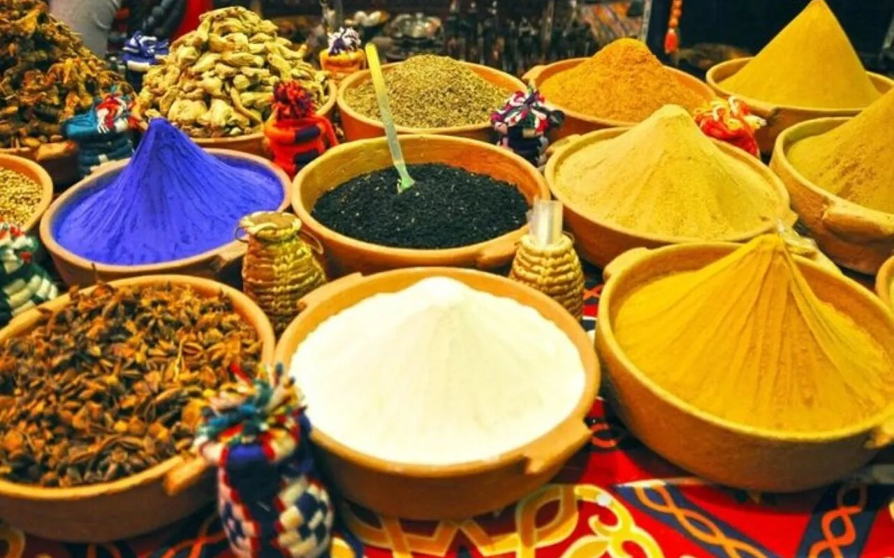 Colorful spices in bowls at a market during a shopping trip from Hurghada.