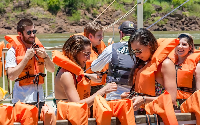 Tourists wearing life jackets on a boat at Iguazú Falls, Brazilian side.
