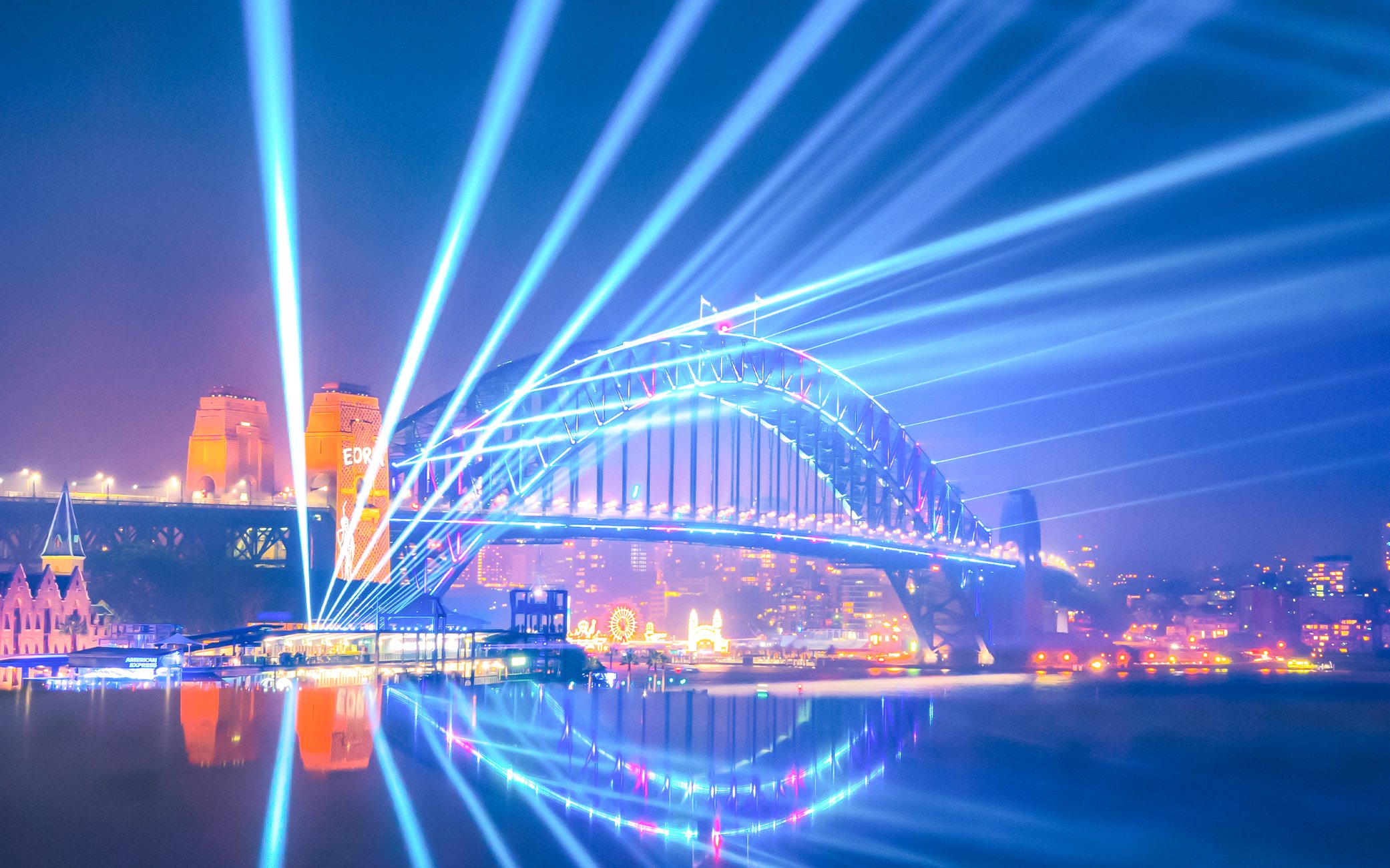 Sydney Harbour Bridge illuminated during Vivid Sydney cruise.