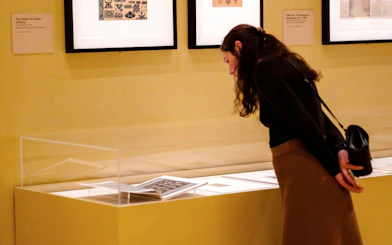 Visitor examining Cartier exhibit at National Gallery Victoria during NGV Friday Nights.