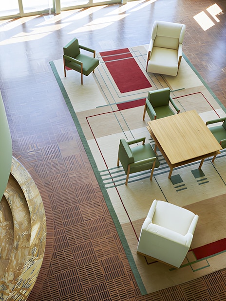 Villa Cavrois interior with modern seating and geometric rug design.