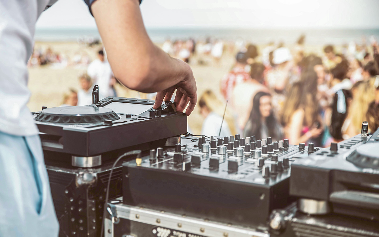 A DJ player playing music in daylight outdoors at Destino Ibiza