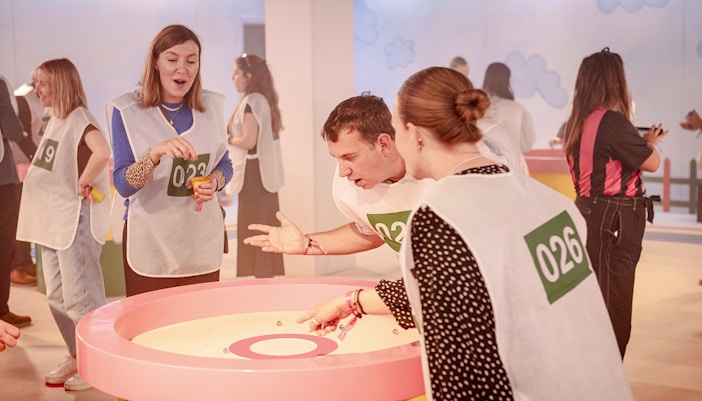 Participants playing marbles at Squid Games experience in London.