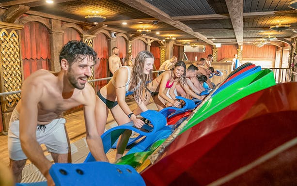 Visitors enjoying water slides at Rulantica indoor water park.
