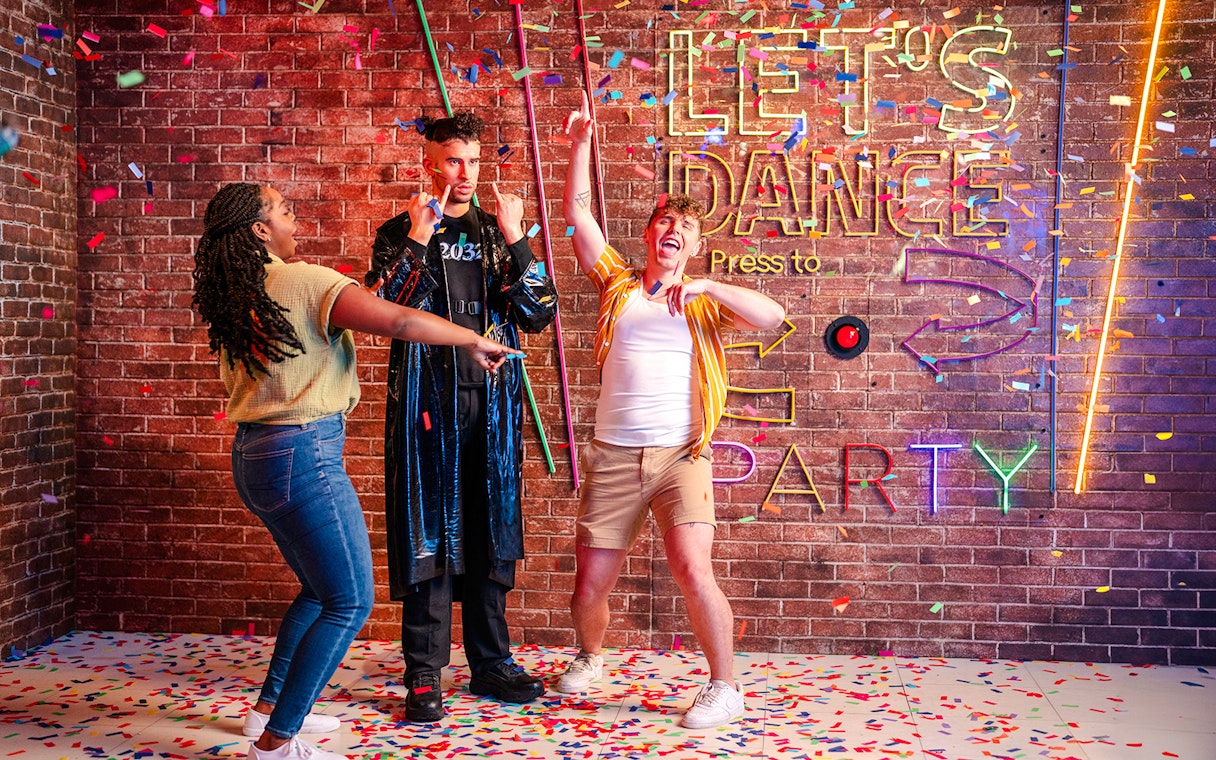 Guests dancing with confetti at Madame Tussauds Orlando party exhibit.
